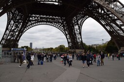 Tourists walking under the Eiffel Tower.jpg