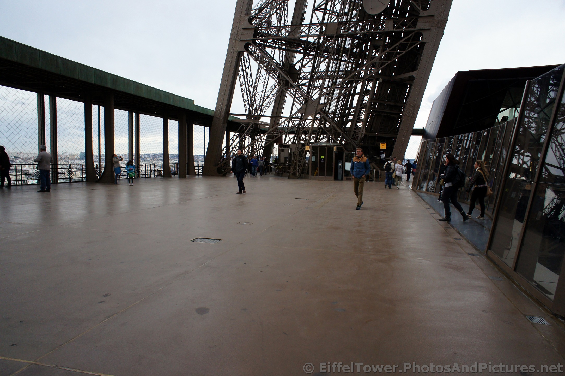 Tourists wonder around Level 1 of the Eiffel Tower.jpg