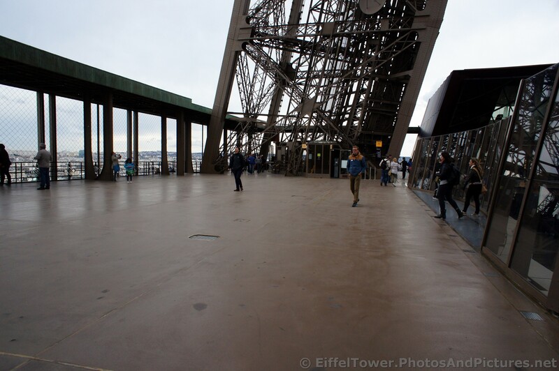 Tourists wonder around Level 1 of the Eiffel Tower.jpg